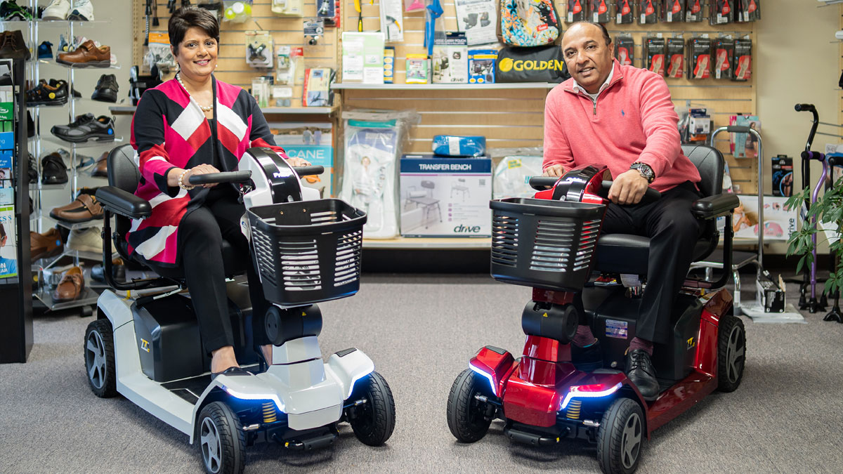 Anita and Roy Patel sitting in electric wheels chairs (Tri-State Medical Supplies)