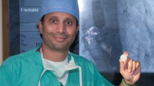 Doctor Chetan Patel, an interventional cardiologist with Prisma Health, holds a WATCHMAN Device