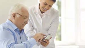 Rheumatologist showing patient how to use app