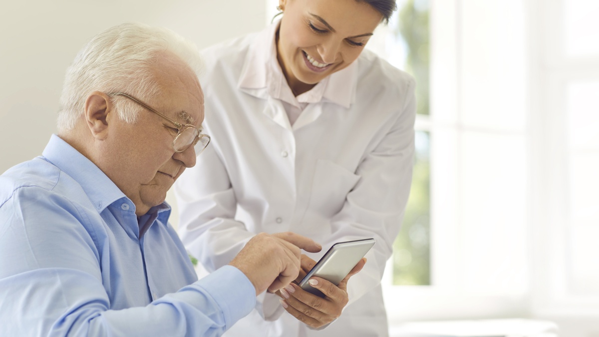 Rheumatologist showing patient how to use app