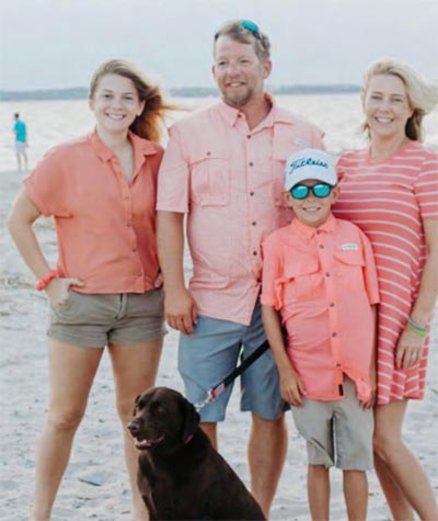 Aaron with his family on the beach.