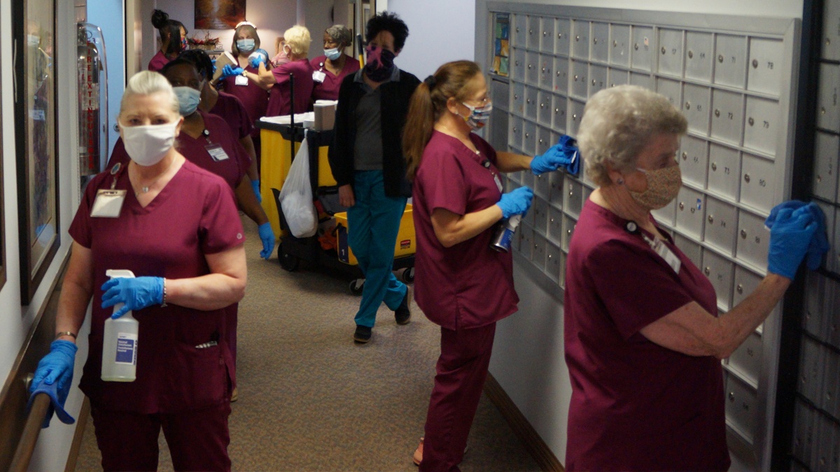 Workers sanitizing senior care facility