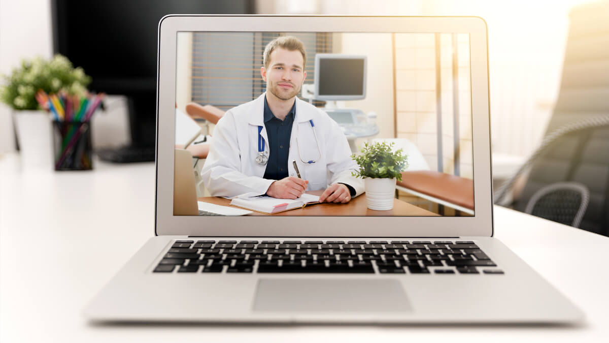 Doctor using telehealth on laptop