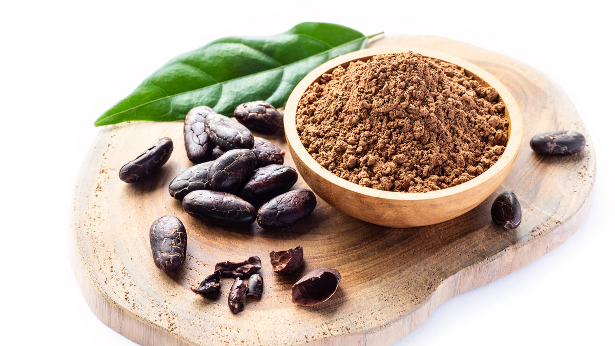Cocoa powder, cocoa beans and a leaf from a cocoa plant