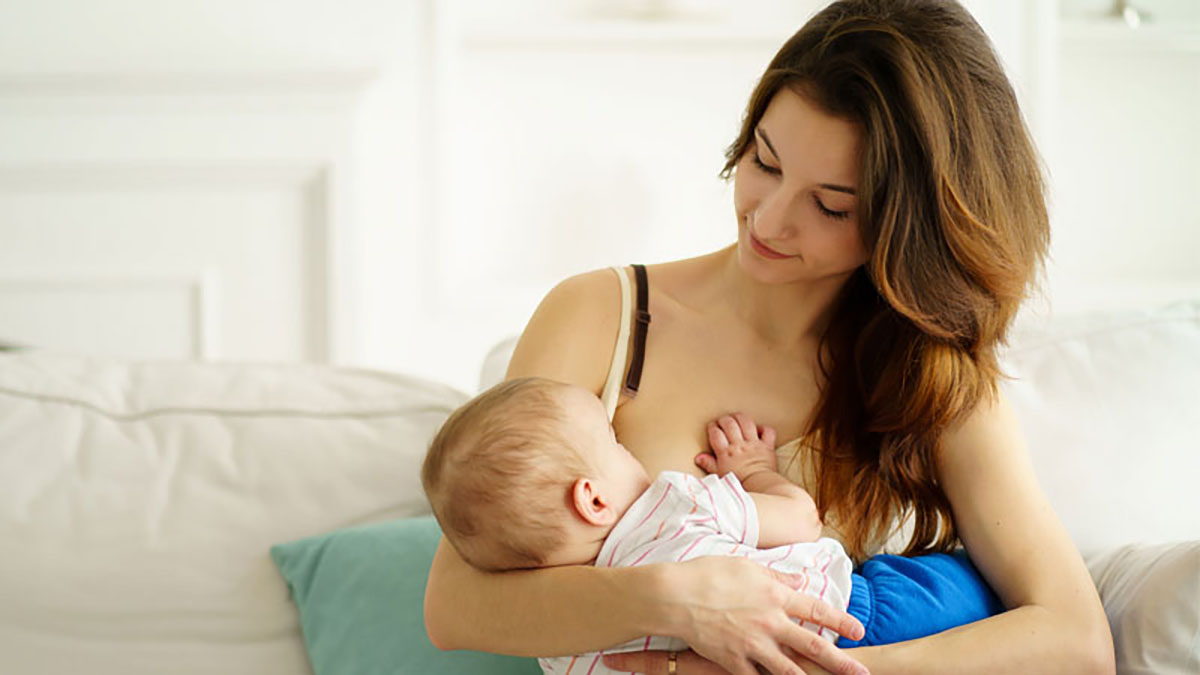Woman who is holding her baby and breastfeeding
