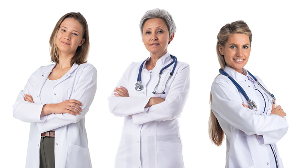 A photo of three women who are in white lab coats