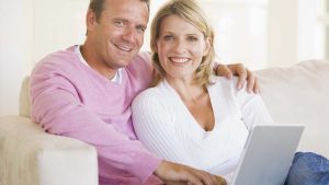 Photo of man and woman with a laptop